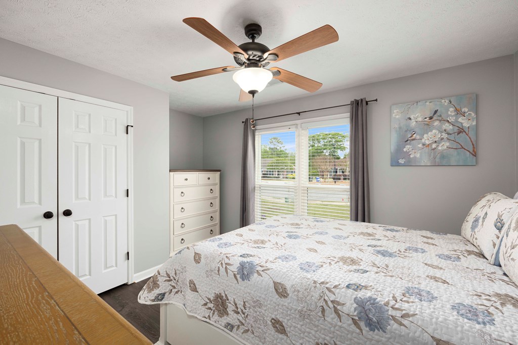 5017 Emerald Isle Court Columbus, GA 31909 - Photo 23 of 37 a bedroom with a large bed and a chandelier