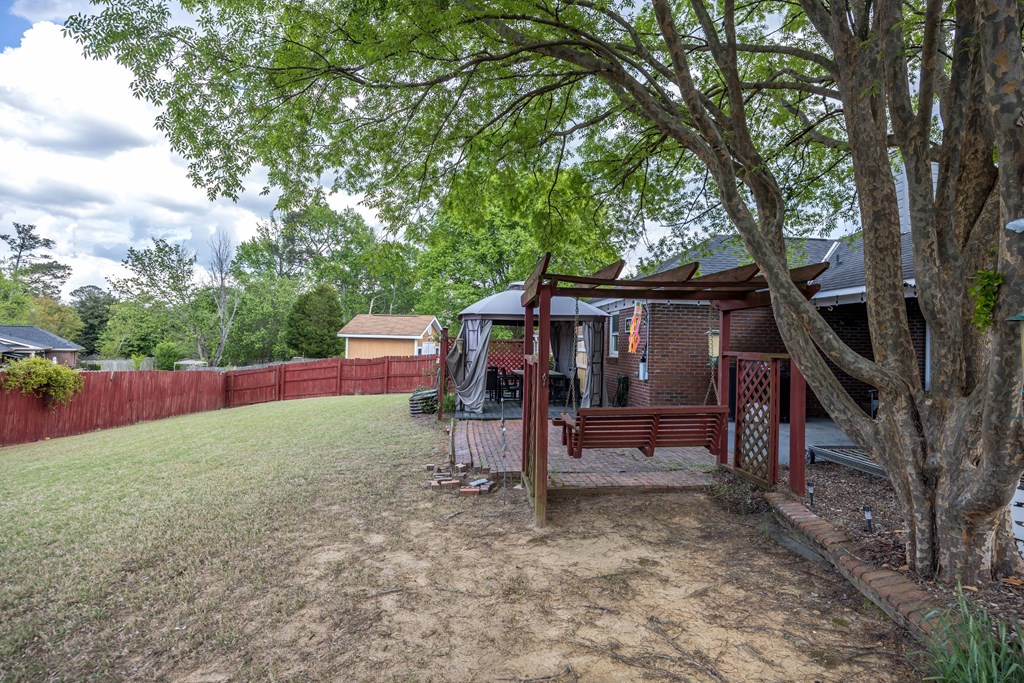 5017 Emerald Isle Court Columbus, GA 31909 - Photo 29 of 37 a view of backyard with wooden fence and a large tree