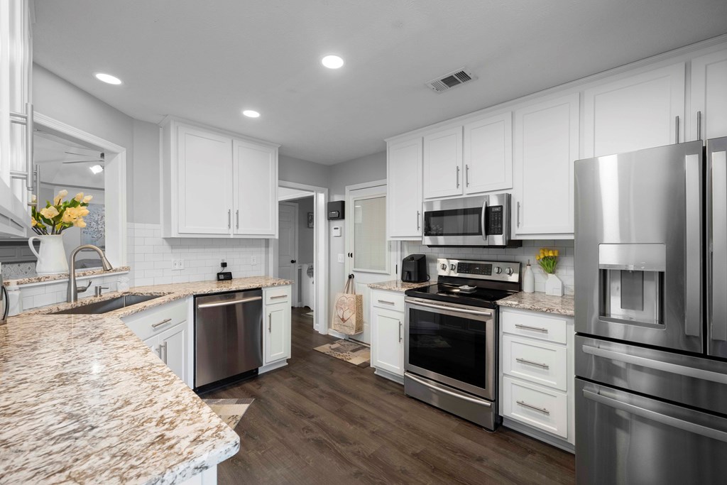 5017 Emerald Isle Court Columbus, GA 31909 - Photo 7 of 37 a kitchen with granite countertop stainless steel appliances and wooden cabinets