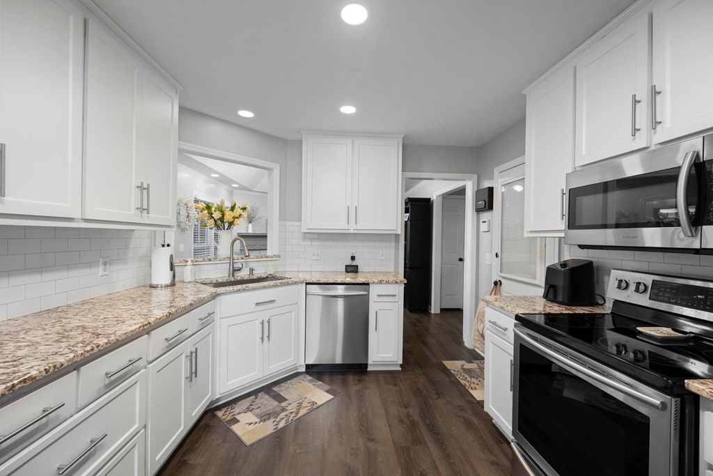 5017 Emerald Isle Court Columbus, GA 31909 - Photo 8 of 37 a kitchen with stainless steel appliances granite countertop a stove a sink and a refrigerator