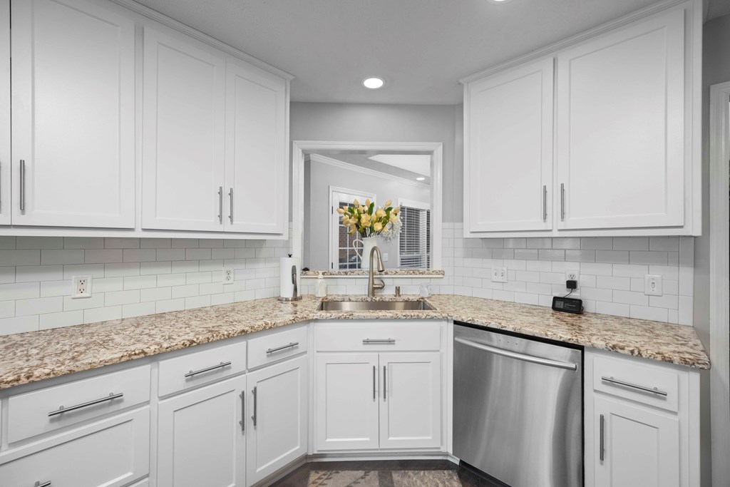 5017 Emerald Isle Court Columbus, GA 31909 - Photo 9 of 37 a kitchen with granite countertop white cabinets white appliances and a sink
