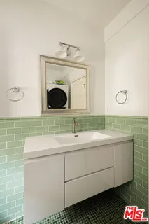 a bathroom with a sink and a washer dryer