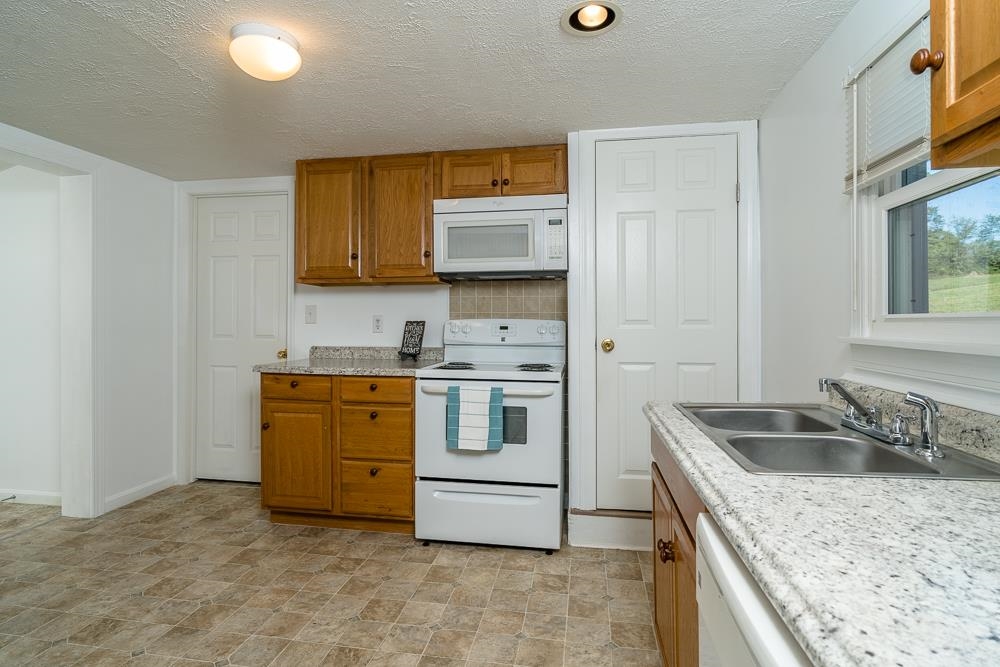 396 Lick Run Road Mount Solon, VA 22843 - Photo 2 of 35 a kitchen that has a sink and a stove in it