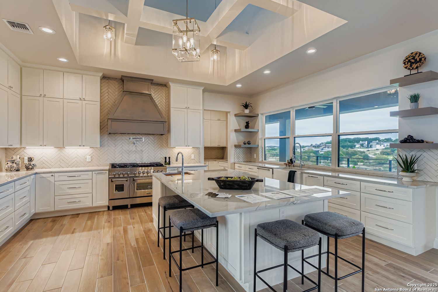 23202 Walker Ridge San Antonio, TX 78255 - Photo 11 of 44 a kitchen with stainless steel appliances granite countertop a stove a sink dishwasher and a stove with wooden floor
