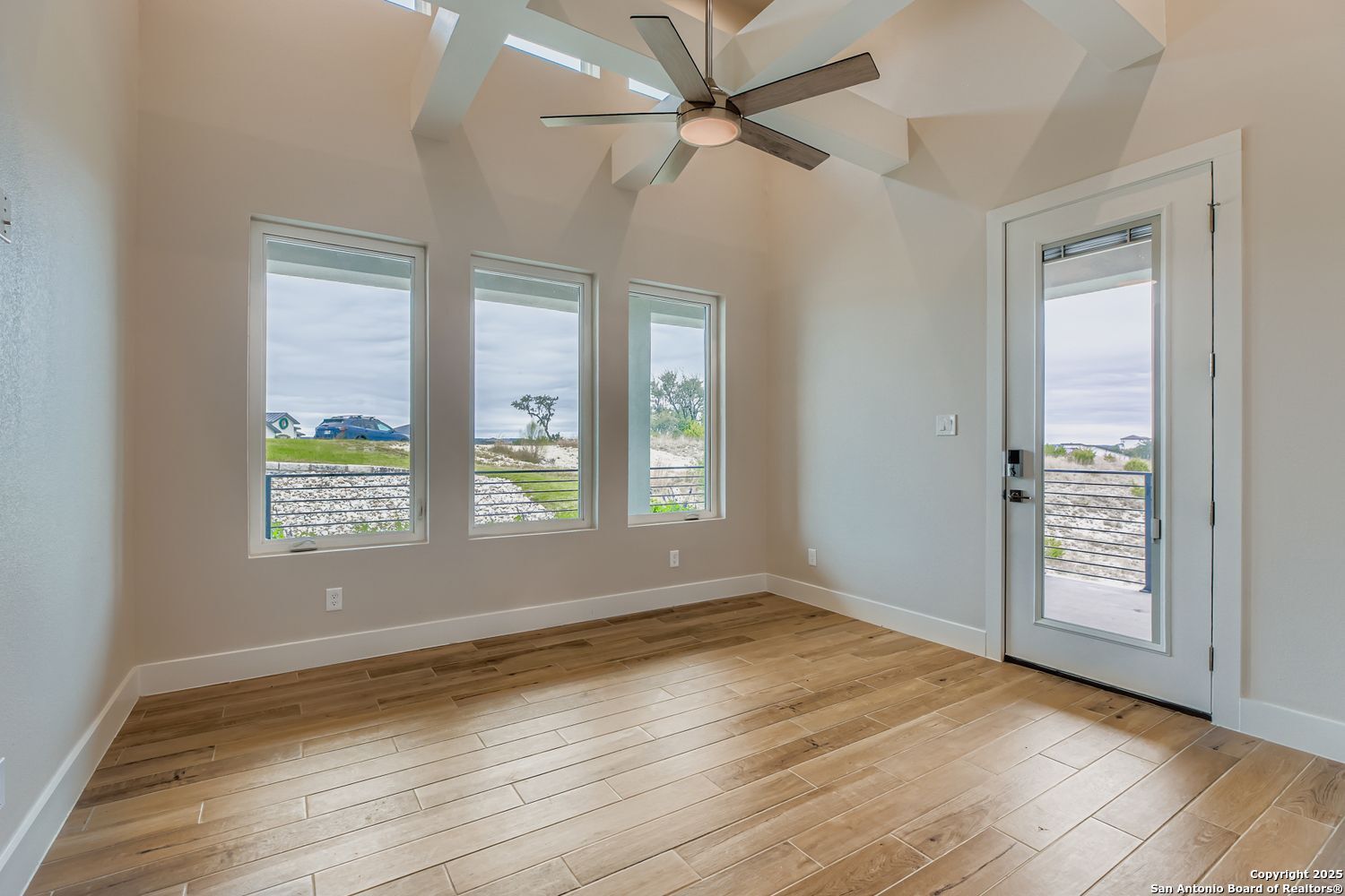 23202 Walker Ridge San Antonio, TX 78255 - Photo 16 of 44 an empty room with wooden floor fan and windows