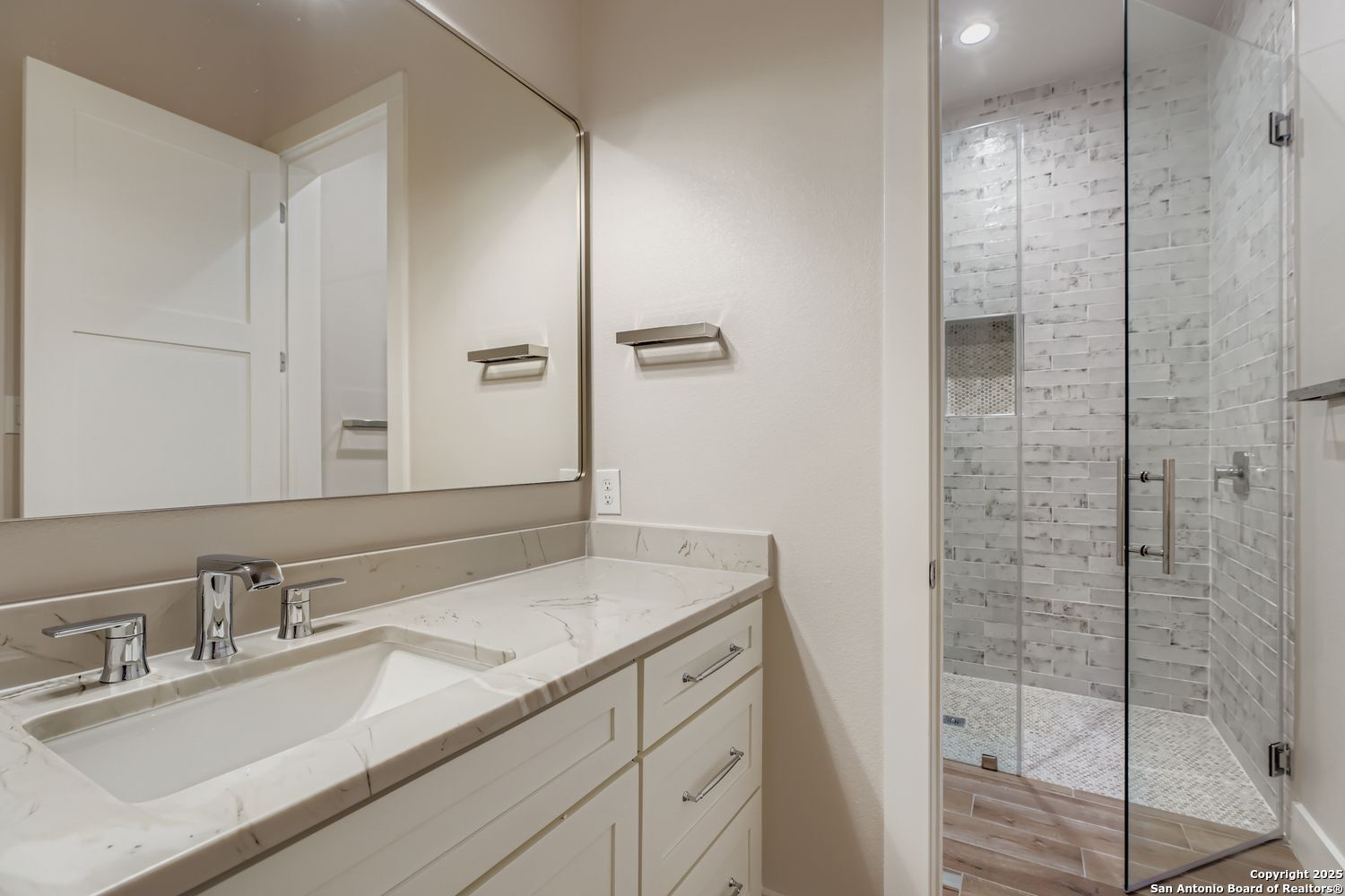 23202 Walker Ridge San Antonio, TX 78255 - Photo 26 of 44 a bathroom with a granite countertop sink a mirror and shower