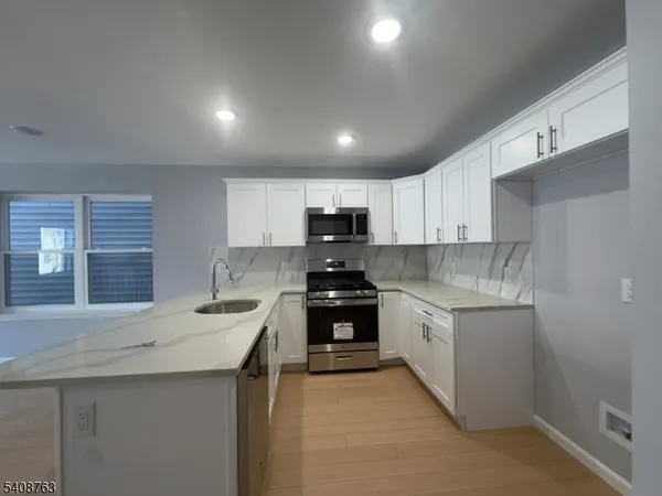 a kitchen with a sink stove and microwave