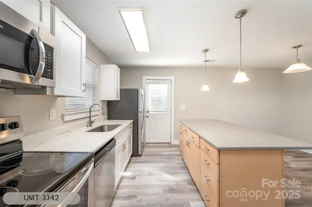 a kitchen with a stove a sink and a refrigerator