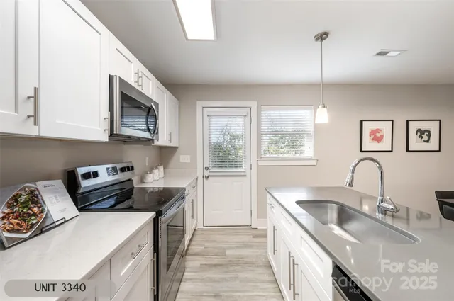 a kitchen that has a sink a stove and window
