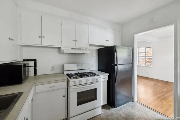 a kitchen with cabinets and stainless steel appliances