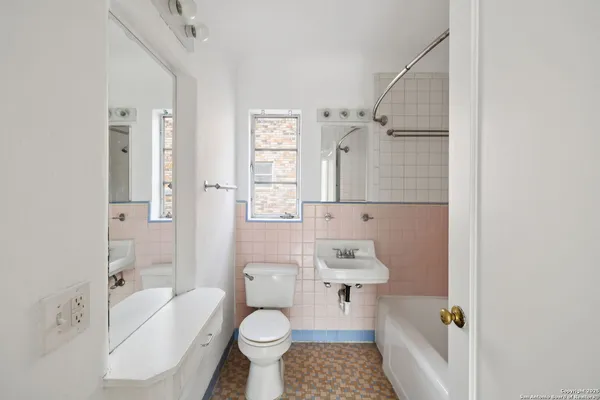 a bathroom with a granite countertop toilet sink and shower