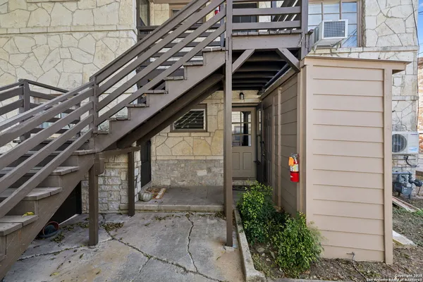 a front view of a house with plants