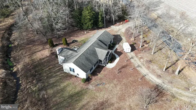 a view of a house with a yard and sitting area