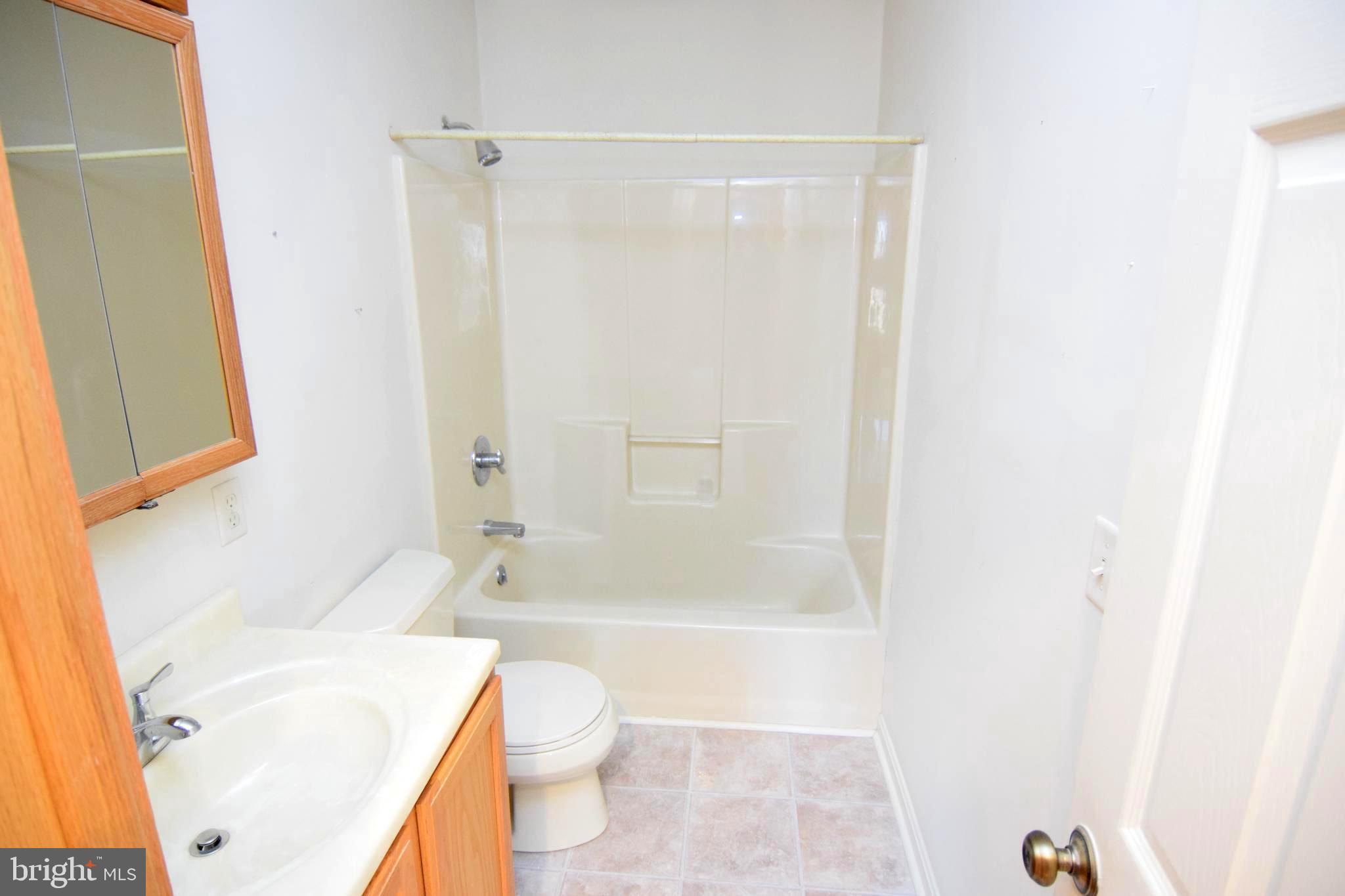 3136 McDowell Road Bridgeville, DE 19933 - Photo 27 of 32 a bathroom with a bathtub shower sink vanity and a toilet