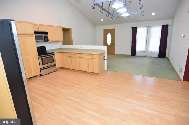 a kitchen with a refrigerator and a sink