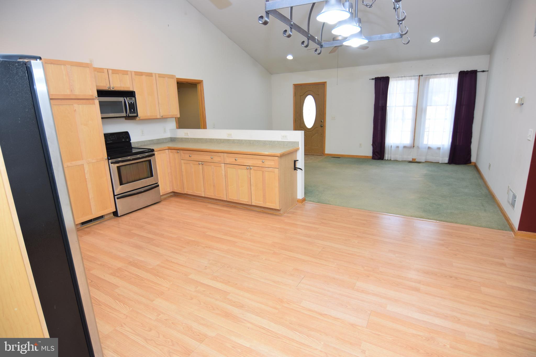 3136 McDowell Road Bridgeville, DE 19933 - Photo 4 of 32 a kitchen with a refrigerator and a sink