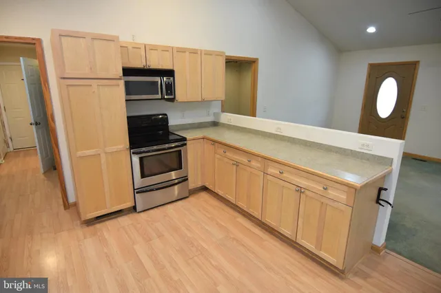 a kitchen with granite countertop a refrigerator and a stove