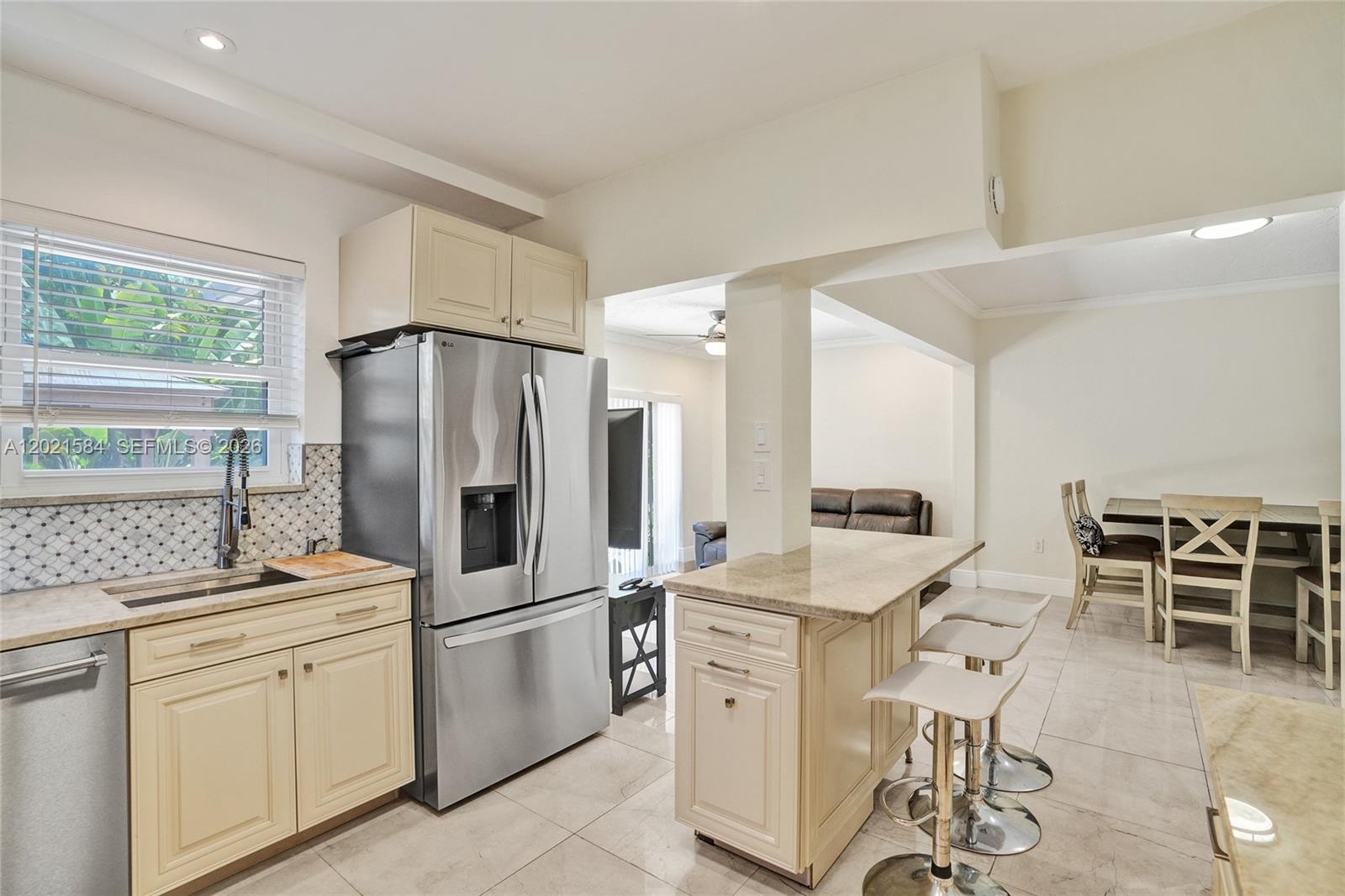 811 Northeast 73rd Street Miami, FL 33138 - Photo 11 of 51 a kitchen with appliances a sink and cabinets