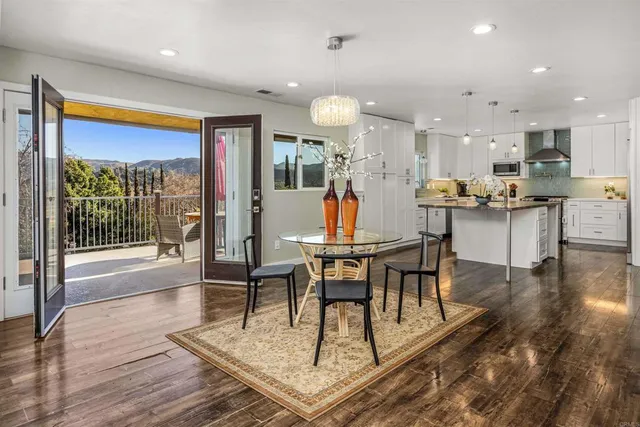 a spacious bathroom with a granite countertop sink a mirror and a bathtub