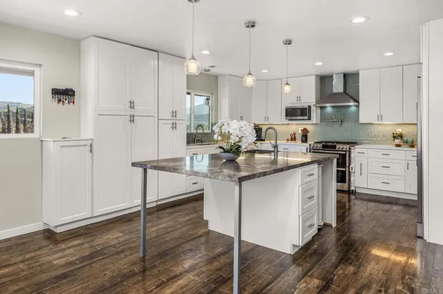 a bathroom with a double vanity sink toilet and shower