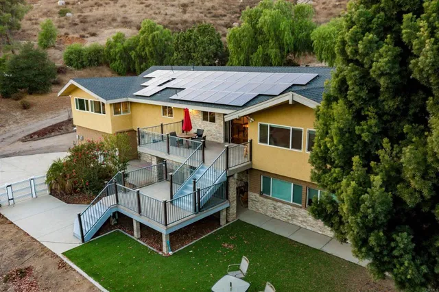 an aerial view of a house with a yard