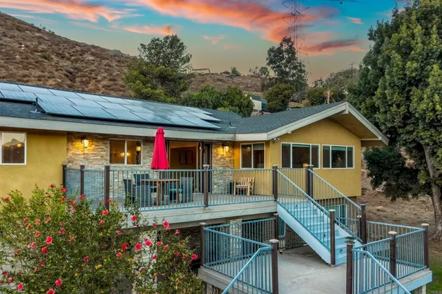 an aerial view of a house with a yard basket ball court and outdoor seating