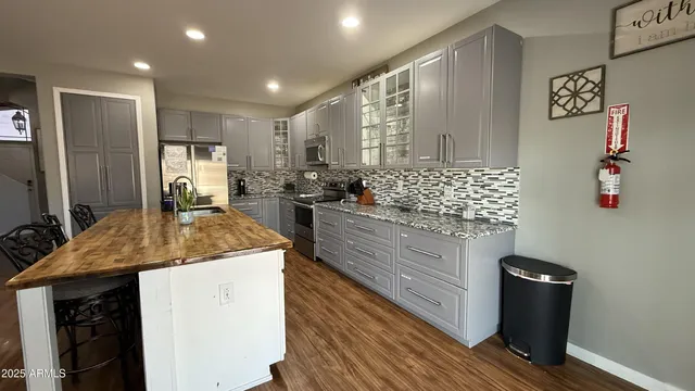 a kitchen with stainless steel appliances granite countertop a sink and cabinets
