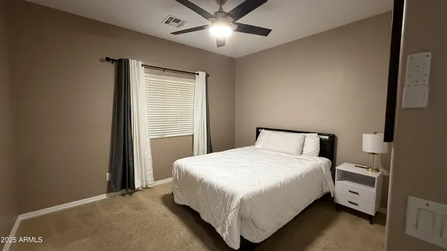 a bedroom with a bed and window