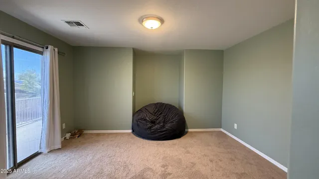 a room with a large bed and a chair