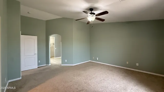 a living room with a bed and a dresser