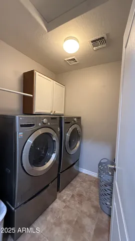 a house with swimming pool and trees in the background