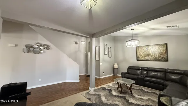 a living room with furniture and a chandelier