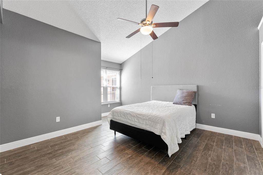 660 Youngstown Parkway, Unit 282 Altamonte Springs, FL 32714 - Photo 13 of 22 a bedroom with a bed chandelier and a window