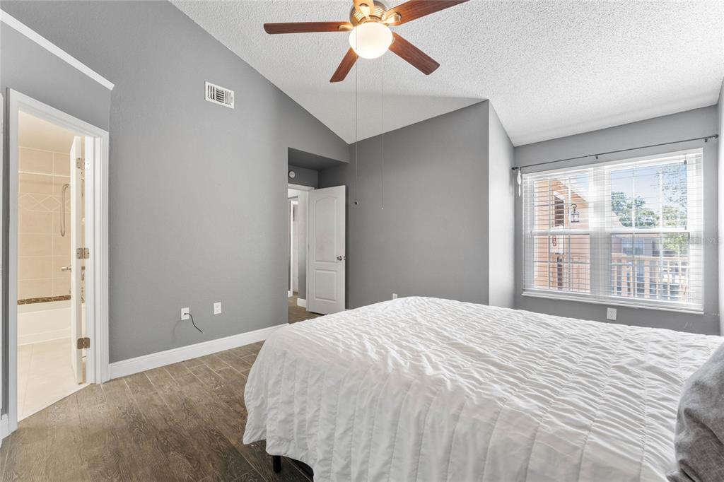 660 Youngstown Parkway, Unit 282 Altamonte Springs, FL 32714 - Photo 14 of 22 a bedroom with a large bed and a chandelier fan