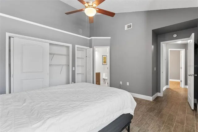 a bedroom with a large bed and a chandelier