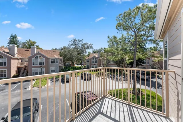 a view of balcony with wooden floor and fence