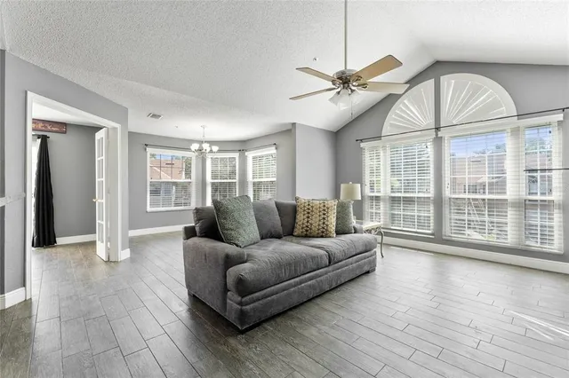a living room with furniture and wooden floor