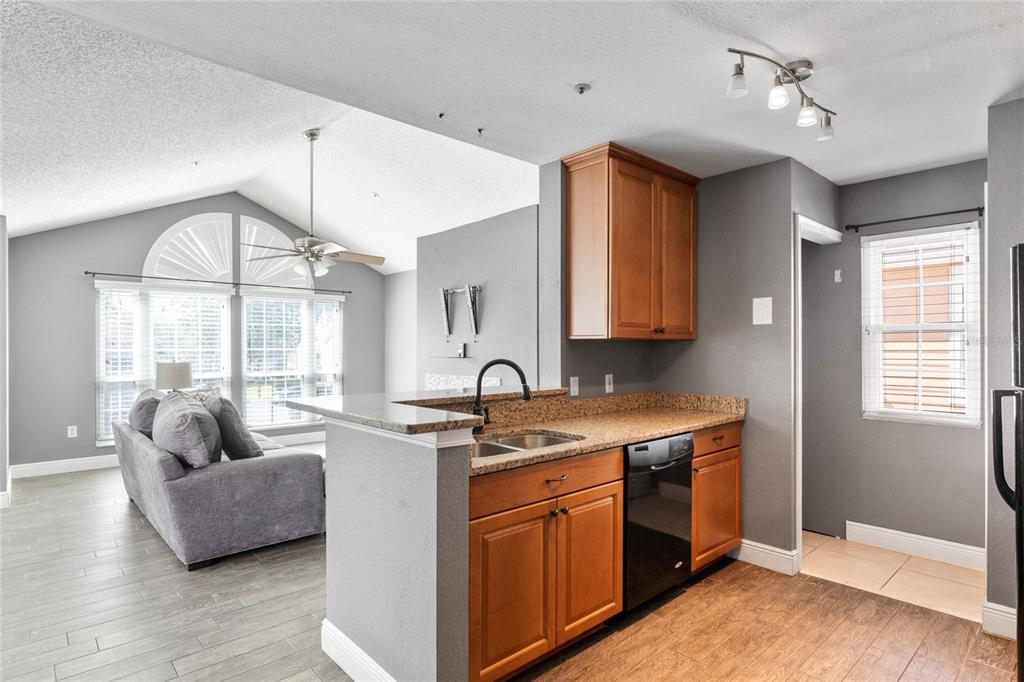 660 Youngstown Parkway, Unit 282 Altamonte Springs, FL 32714 - Photo 6 of 22 a open kitchen with stainless steel appliances granite countertop a sink a stove and a refrigerator