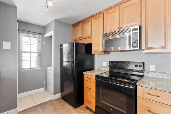 a kitchen with stainless steel appliances granite countertop a refrigerator stove and sink