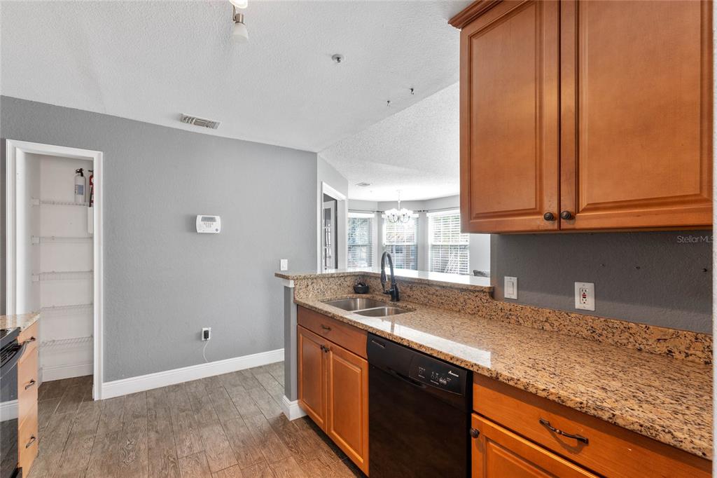 660 Youngstown Parkway, Unit 282 Altamonte Springs, FL 32714 - Photo 9 of 22 a kitchen with stainless steel appliances granite countertop a sink a stove and a microwave oven