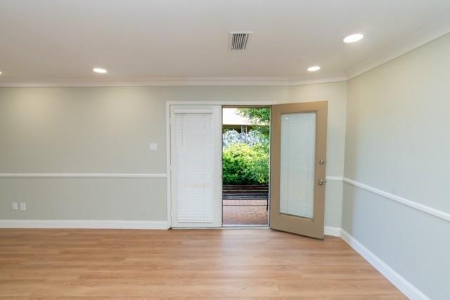 106 Mapleleaf Lane Coppell, TX 75019 - Photo 16 of 36 Wood-finish flooring throughout, featuring a single-panel door with integrated blinds, recessed ceiling lighting, crown molding, and wainscoting