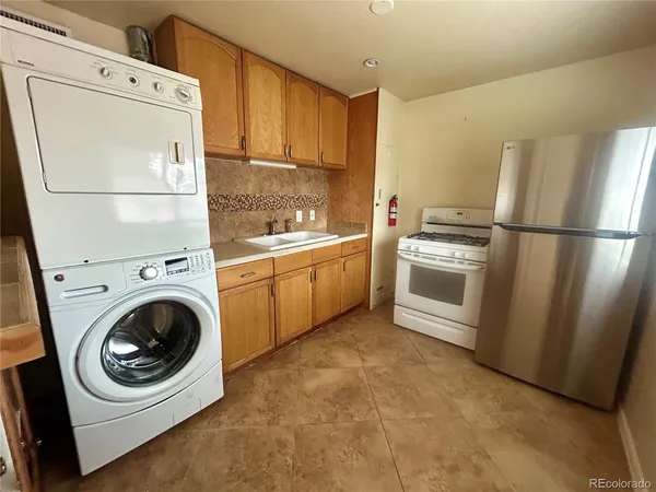 a view of a kitchen with wooden floor and electronic appliances