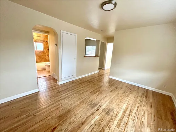 a view of a room with wooden floor and cabinet
