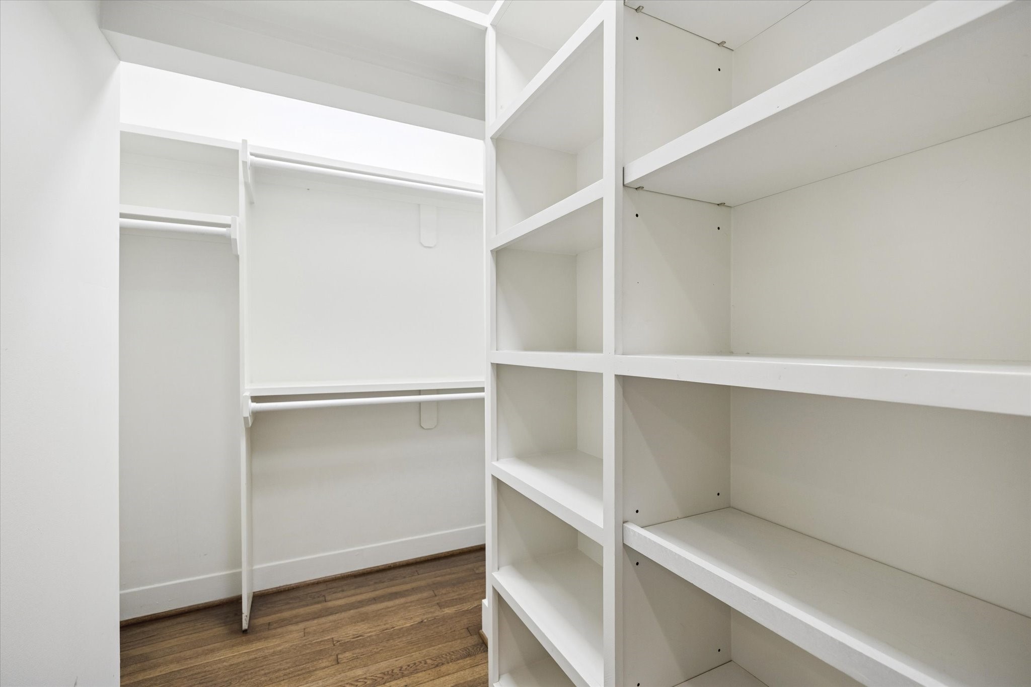 2109 Colquitt Street Houston, TX 77098 - Photo 19 of 28 The primary bedroom walk-in closet offers extensive built-in shelving and hanging space for organized storage.