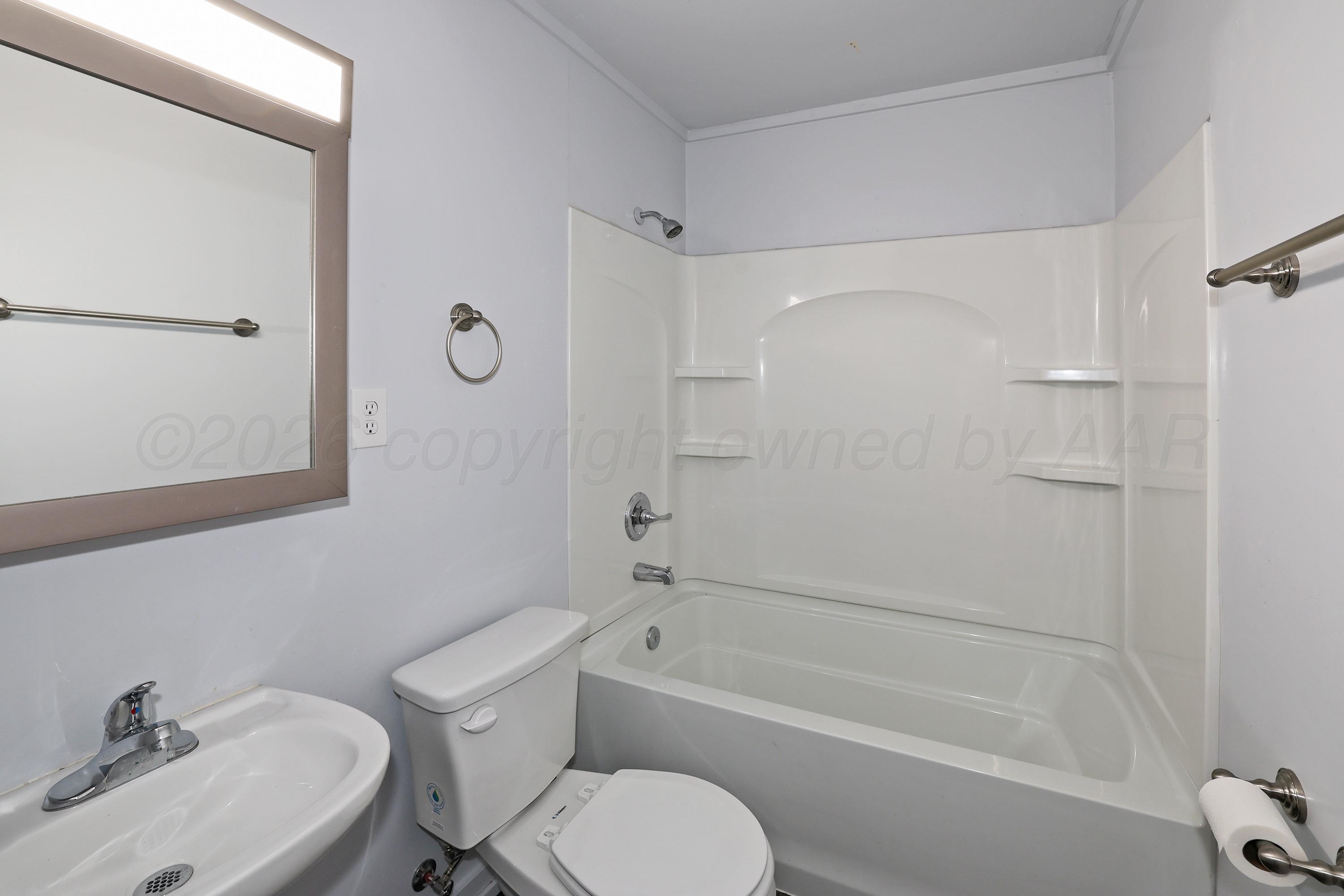 3703 South Monroe Street Amarillo, TX 79110 - Photo 11 of 14 a bathroom with a sink toilet and shower