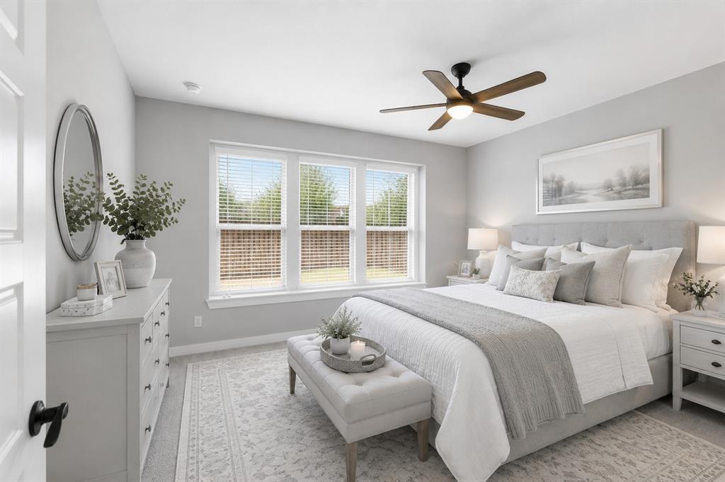 3311 Willena Road Melissa, TX 75454 - Photo 11 of 40 Bright bedroom featuring multiple windows, a ceiling fan with integrated lighting, soft gray walls, and light-colored carpeting