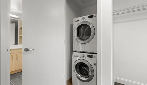 a view of a hallway with washer and dryer