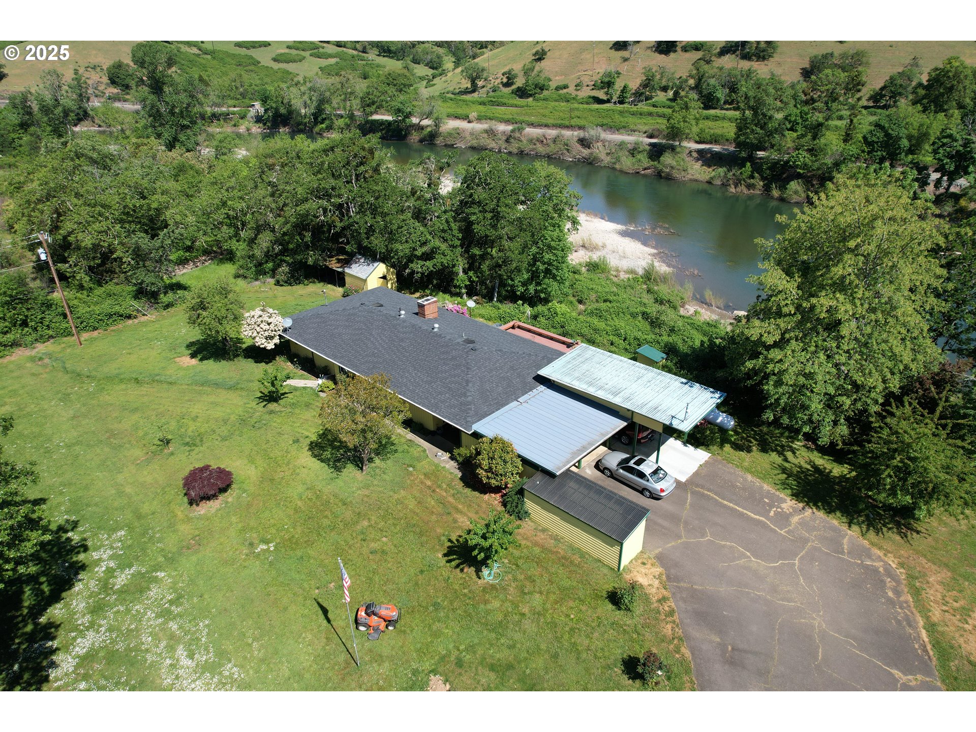 an aerial view of a house with garden space and lake view