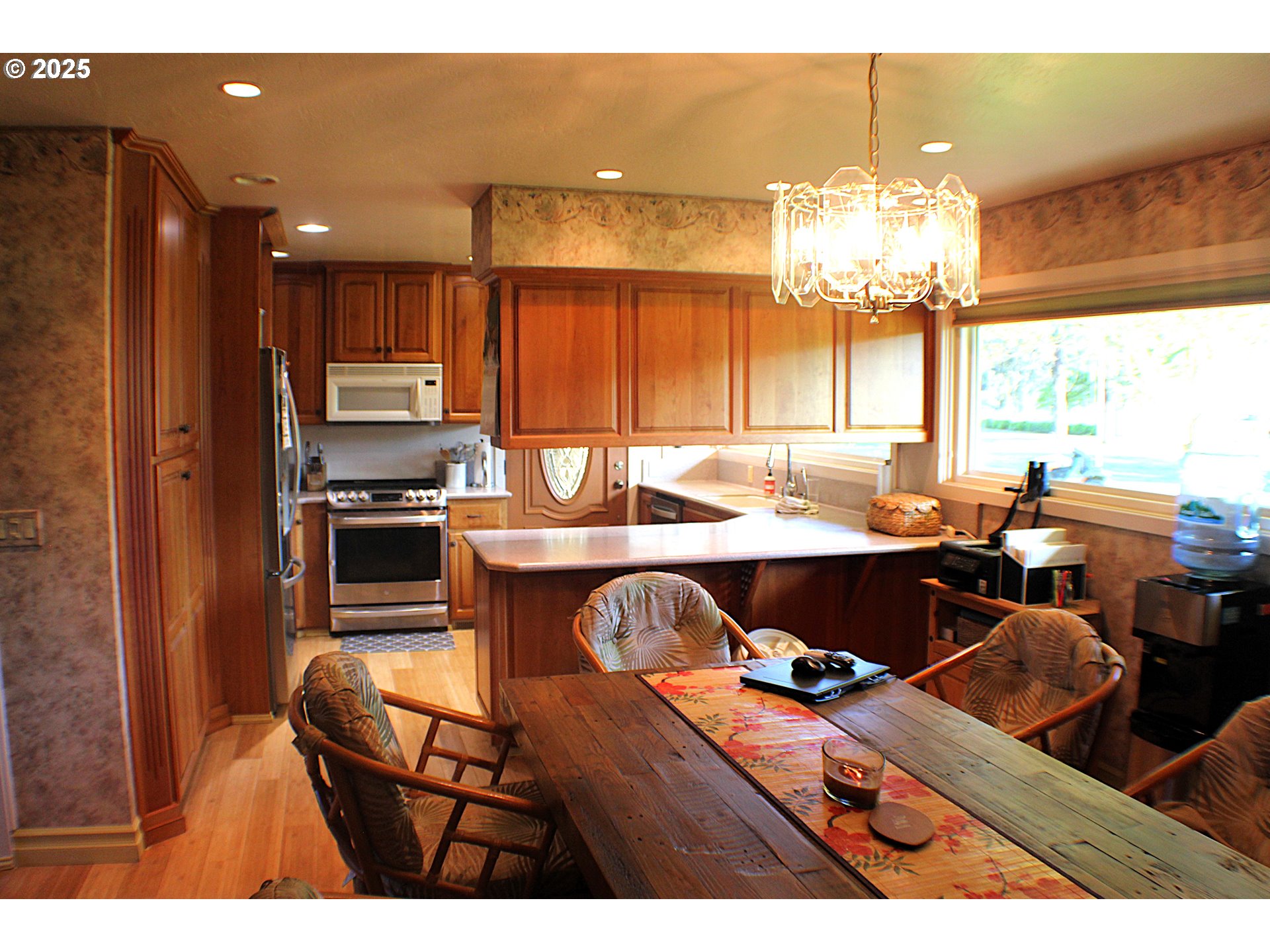 180 Ruckles Drive Myrtle Creek, OR 97457 - Photo 13 of 45 a kitchen with kitchen island granite countertop a stove dining table and chairs