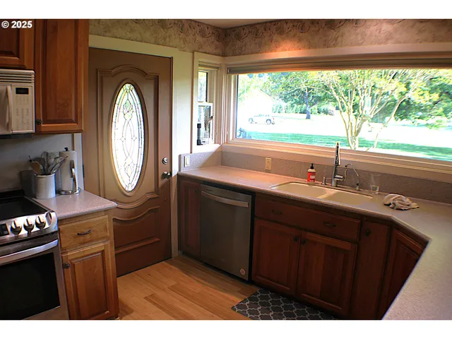 a bathroom with a sink mirror and window